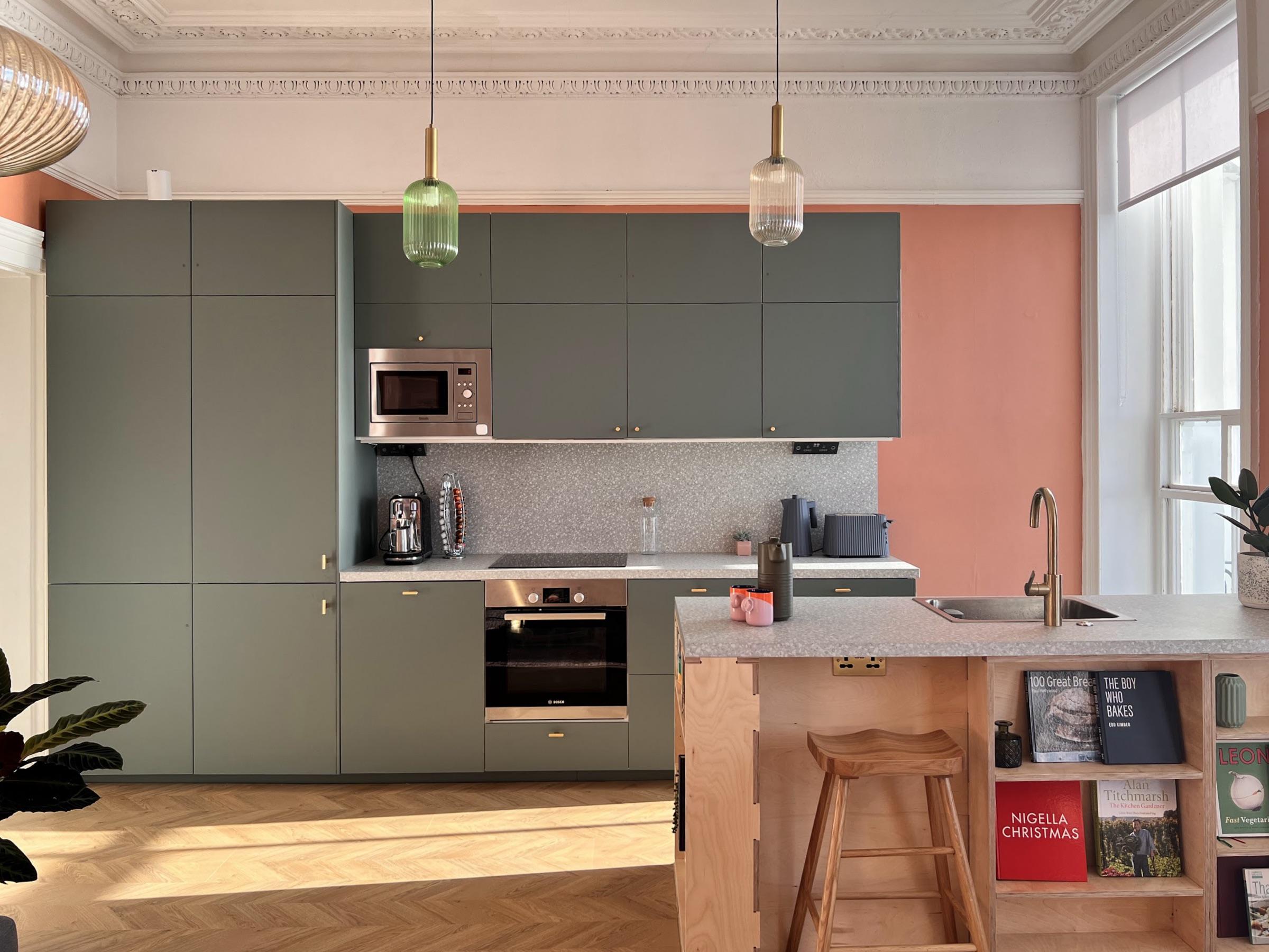 Sage green kitchen with plywood island