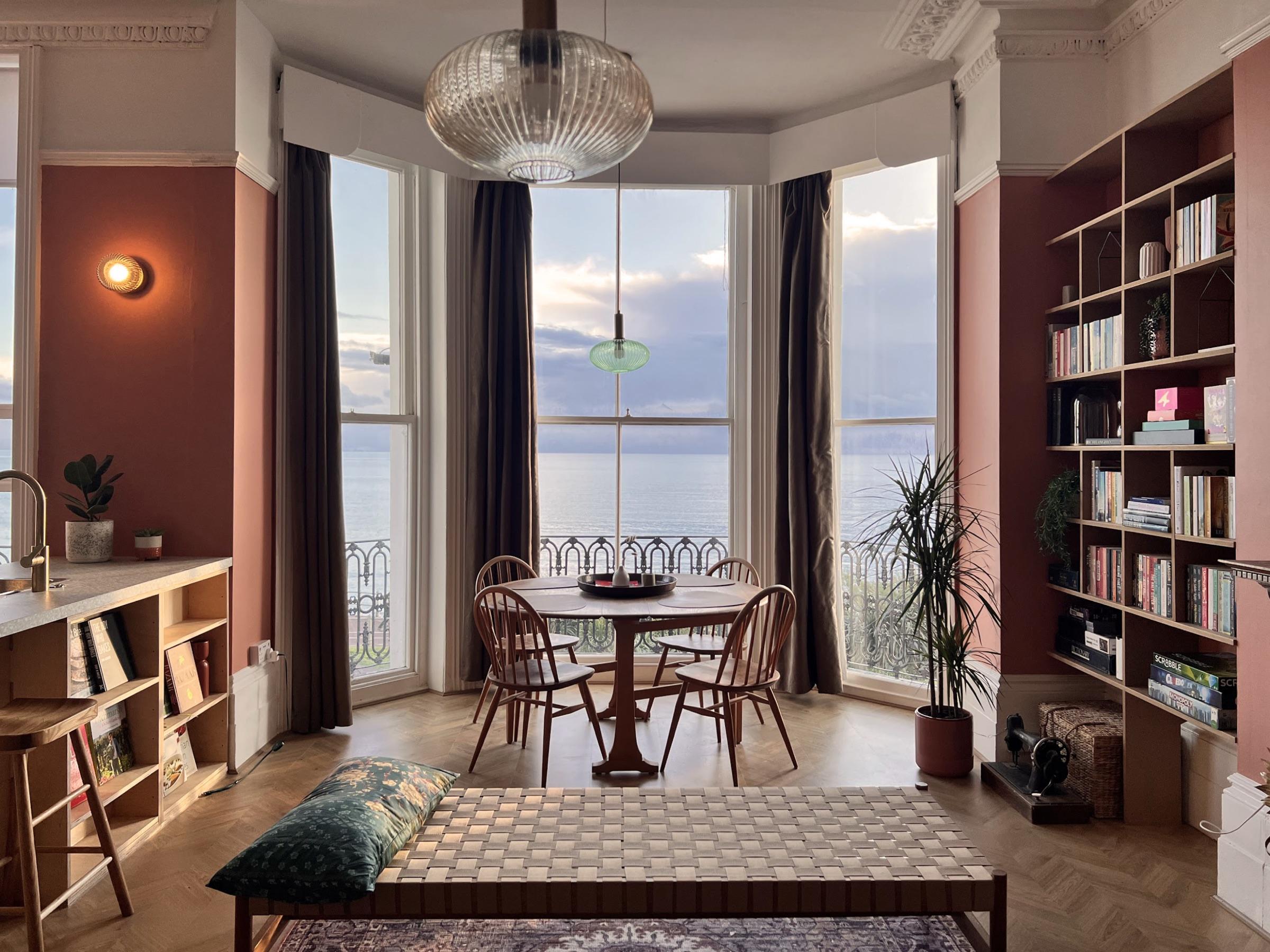 Dining table in the bay window looking out to sea